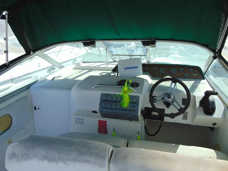 Slide: The Image of 1995 Sea Ray 290DA boat cockpit with steering wheel and navigation equipment. - 5