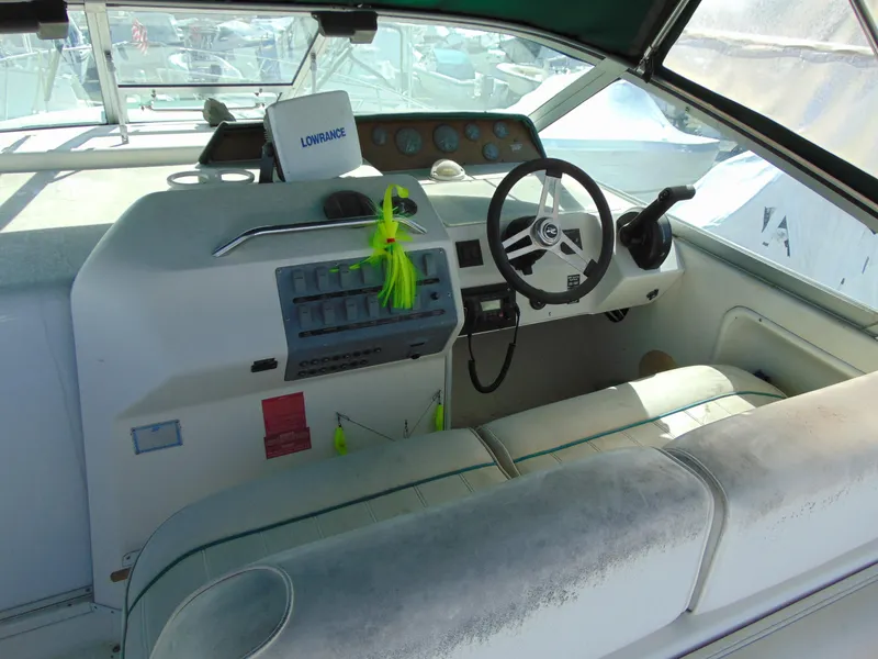 Slide: The Image of 1995 Sea Ray 290DA boat cockpit with steering wheel and control panel. - 6