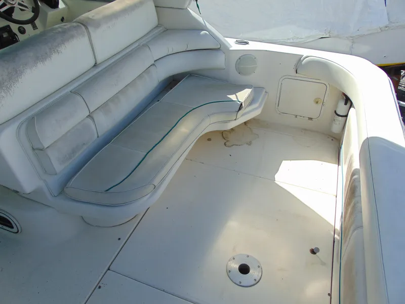 Slide: The Image of 1995 Sea Ray 290DA boat interior with white seating and storage compartment. - 7