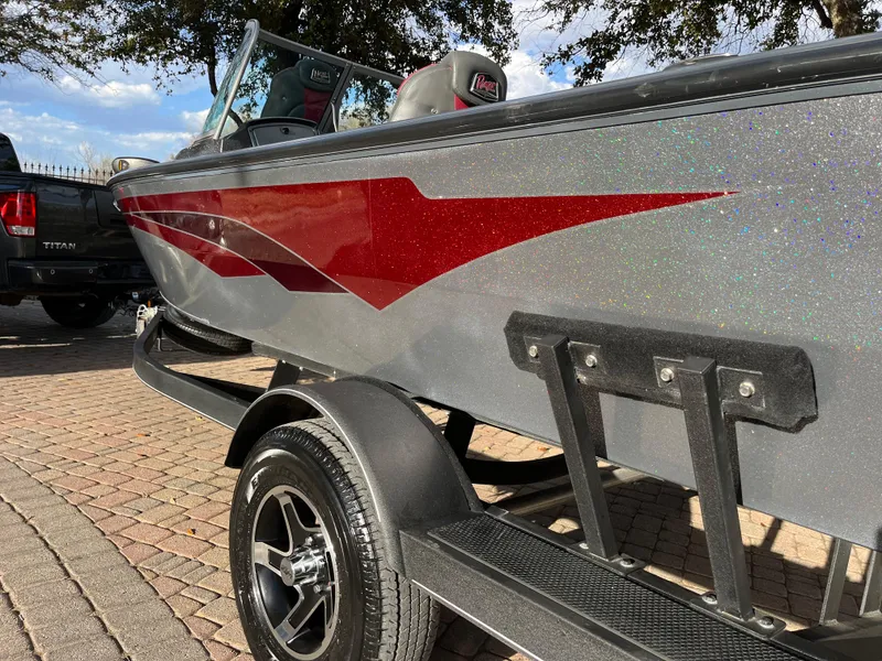 Slide: The Image of 2021 Ranger VS1782 WT boat with red graphics on a trailer. - 10