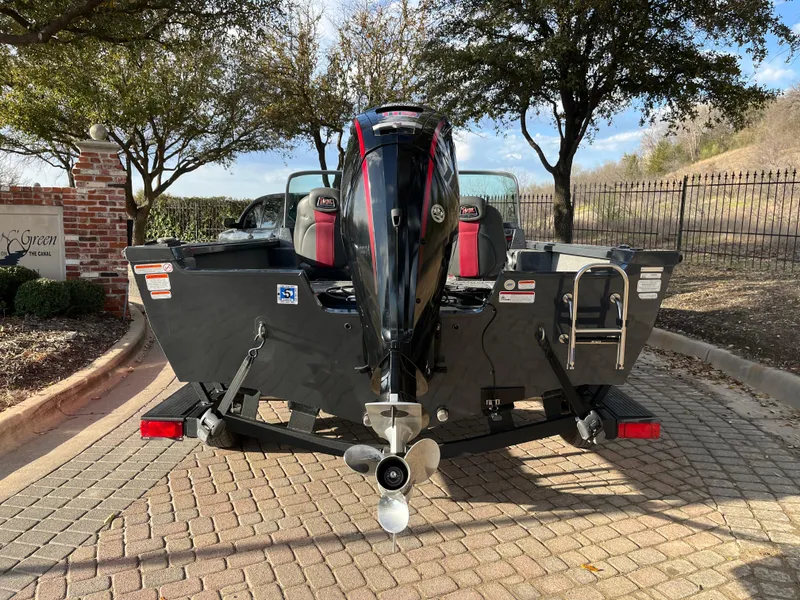Slide: The Image of 2021 Ranger VS1782 WT boat on trailer, rear view, parked on cobblestone driveway. - 12