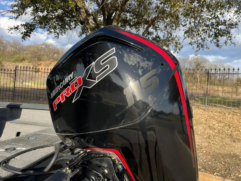 Slide: The Image of 2021 Ranger VS1782 WT boat with Mercury Pro XS engine, outdoors under a tree. - 13