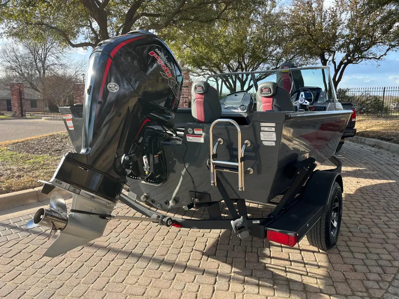 Slide: The Image of 2021 Ranger VS1782 WT boat with powerful outboard motor, parked on a brick driveway. - 15