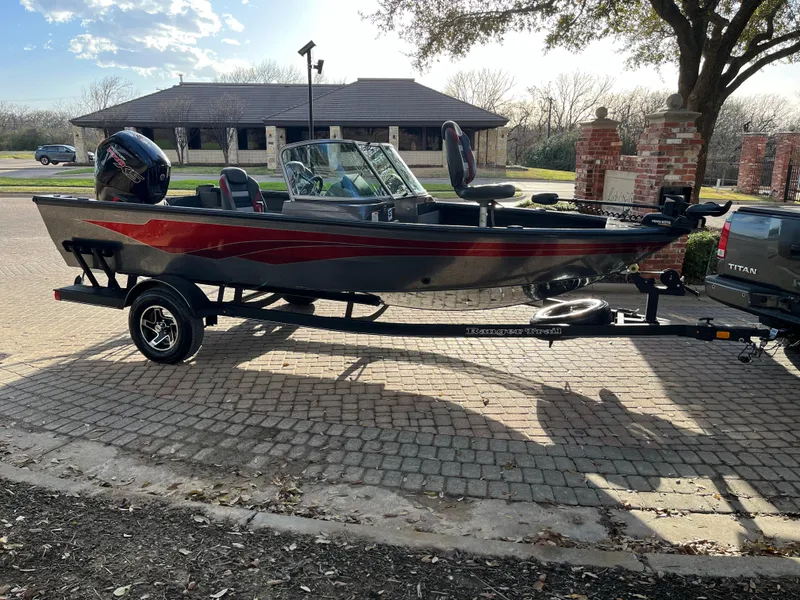 Slide: The Image of 2021 Ranger VS1782 WT boat on trailer, parked outdoors in sunny setting. - 18