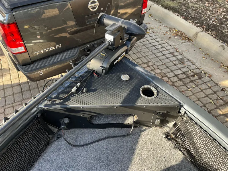 Slide: The Image of 2021 Ranger VS1782 WT boat with trolling motor, parked near a Nissan Titan truck. - 25