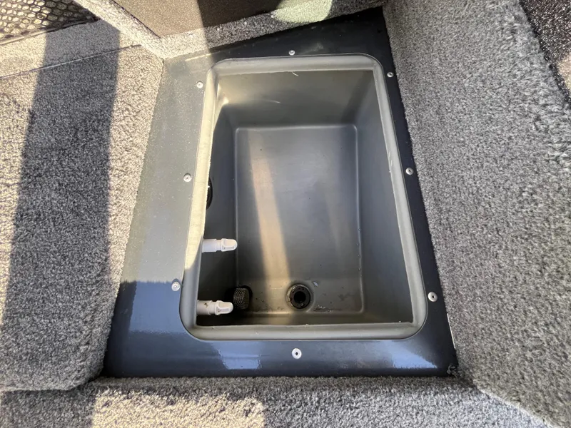 Slide: The Image of Livewell compartment in 2021 Ranger VS1782 WT boat, featuring carpeted interior. - 32