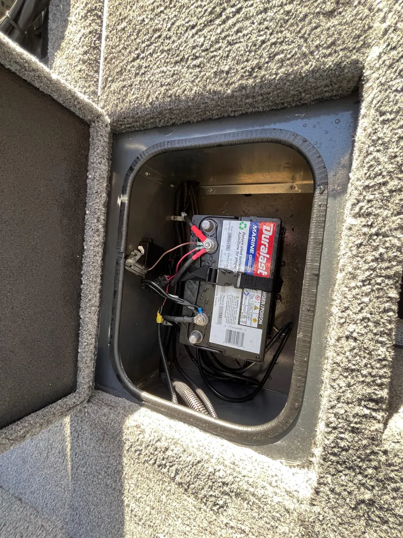 Slide: The Image of 2021 Ranger VS1782 WT boat battery compartment with installed marine battery. - 44