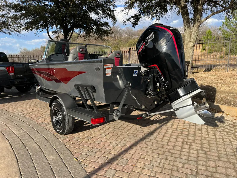 Slide: The Image of 2021 Ranger VS1782 WT boat on trailer, featuring a powerful outboard motor. - 6