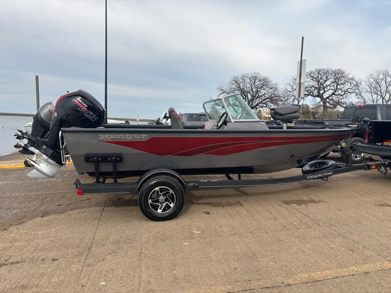 Slide: The Image of 2021 Ranger VS1782 WT fishing boat on trailer, parked near a lake. - 8