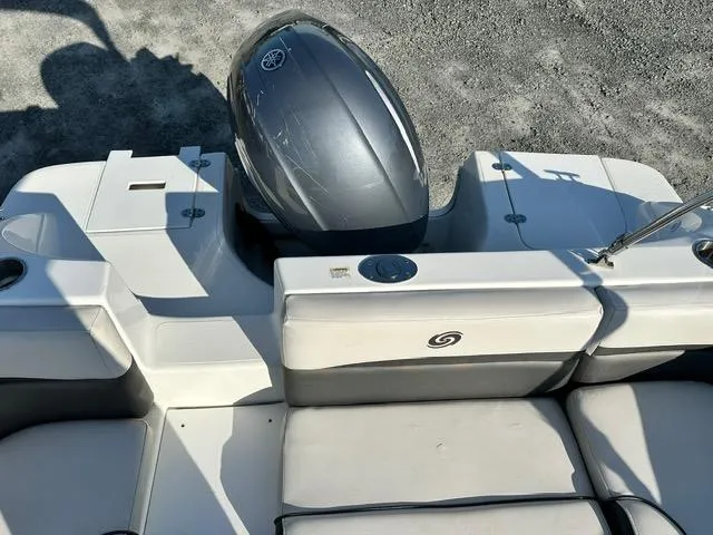 Slide: The Image of 2018 Godfrey Hurricane 217SD boat with outboard motor, white seating, and sleek design. - 15