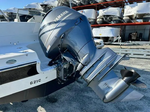 Slide: The Image of 2018 Godfrey Hurricane 217SD boat with Yamaha outboard motor in a storage yard. - 17