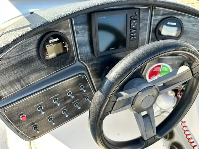 Slide: The Image of Control panel of 2018 Godfrey Hurricane 217SD boat with steering wheel and gauges. - 3