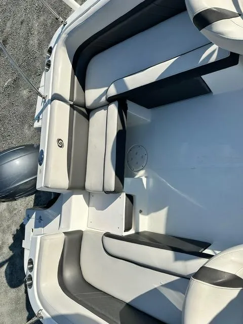 Slide: The Image of 2018 Godfrey Hurricane 217SD boat interior with cushioned seating and sleek design. - 8