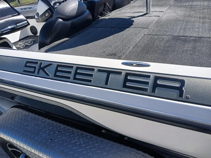 Slide: The Image of 2006 Skeeter 21 boat interior with logo, featuring seating and deck area. - 15