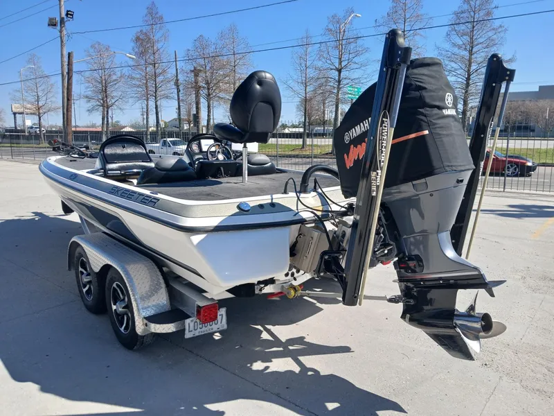 Slide: The Image of 2006 Skeeter 21 boat with Yamaha VMAX engine, parked on a trailer. - 16