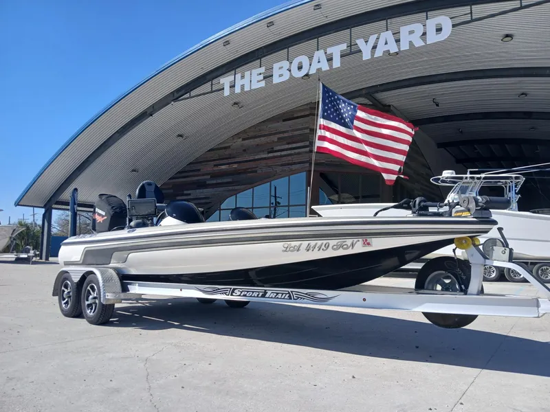 Slide: The Image of 2006 Skeeter 21 boat on trailer, parked at The Boat Yard, with American flag. - 19