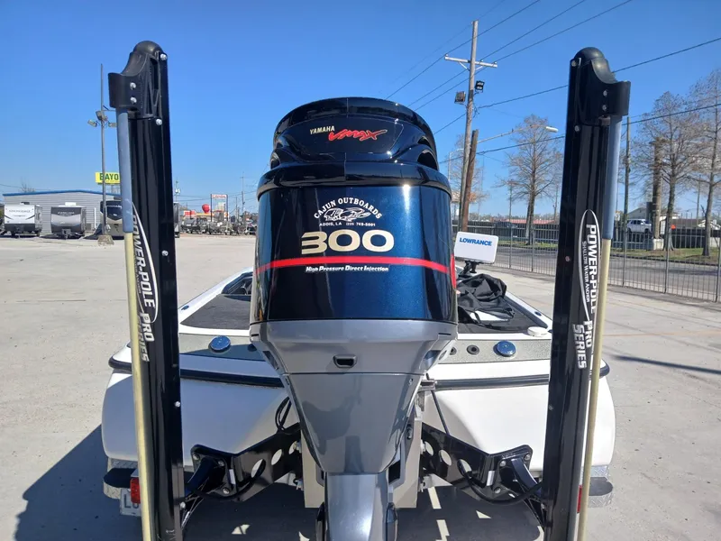 Slide: The Image of 2006 Skeeter 21 boat with Yamaha 300 outboard motor, parked outdoors. - 4