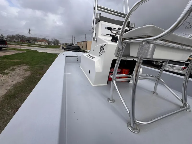 Slide: The Image of 2019 Catalyst 260 Catamaran with seating and control panel, under cloudy skies. - 11