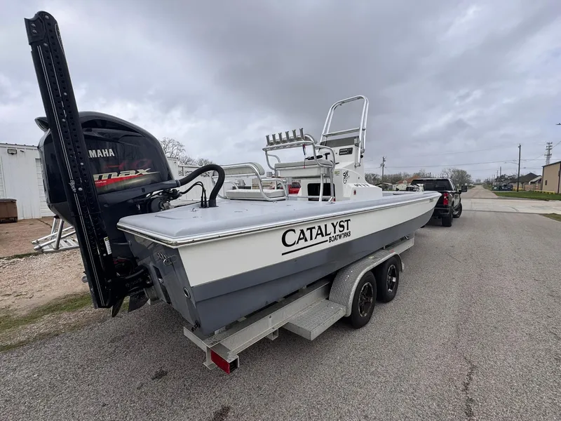 Slide: The Image of 2019 Catalyst 260 Catamaran on trailer, featuring Yamaha outboard motor, parked on a cloudy day. - 3