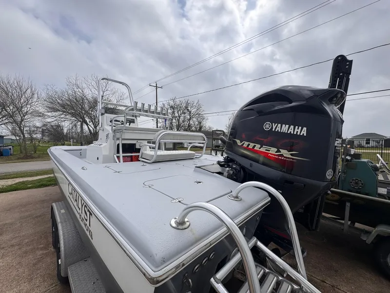 Slide: The Image of 2019 Catalyst 260 Catamaran with Yamaha outboard motor on trailer, parked outdoors. - 4