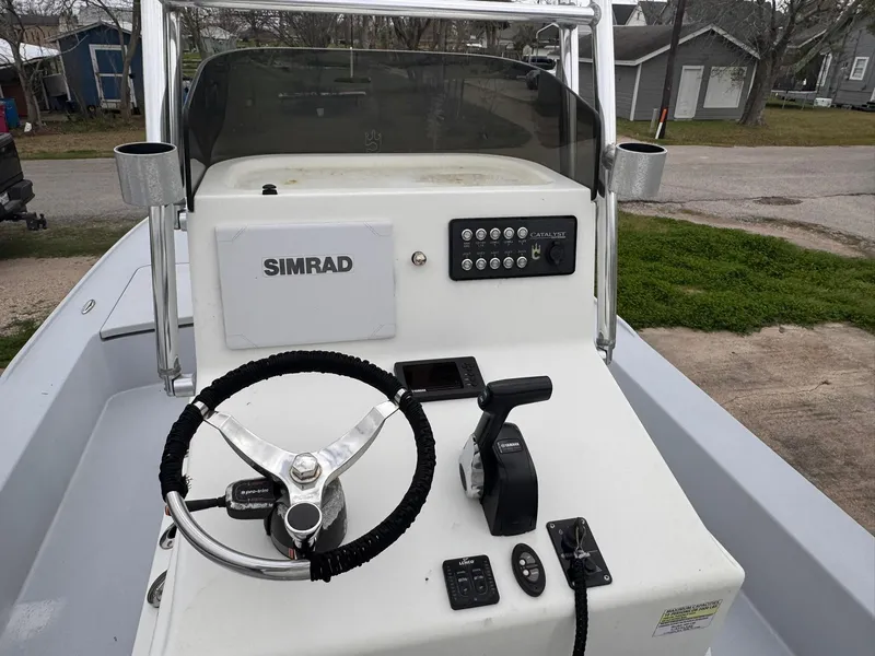 Slide: The Image of 2019 Catalyst 260 Catamaran helm with Simrad electronics and steering wheel. - 6