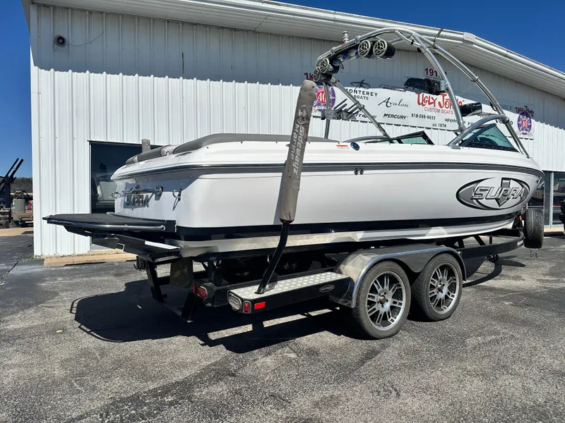 Slide: The Image of 2008 Supra Launch 24 SSV GG Edition boat on trailer outside a building. - 3