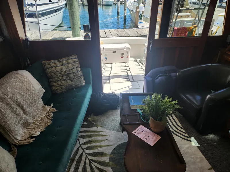 Slide: The Image of Interior of 1977 Pacemaker 40 Sportfisherman with cozy seating and marina view. - 14