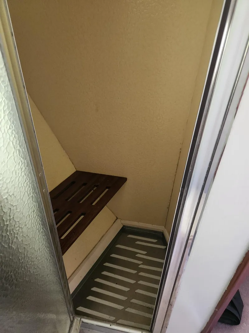 Slide: The Image of Shower area in 1977 Pacemaker 40 Sportfisherman boat with wooden seat. - 21