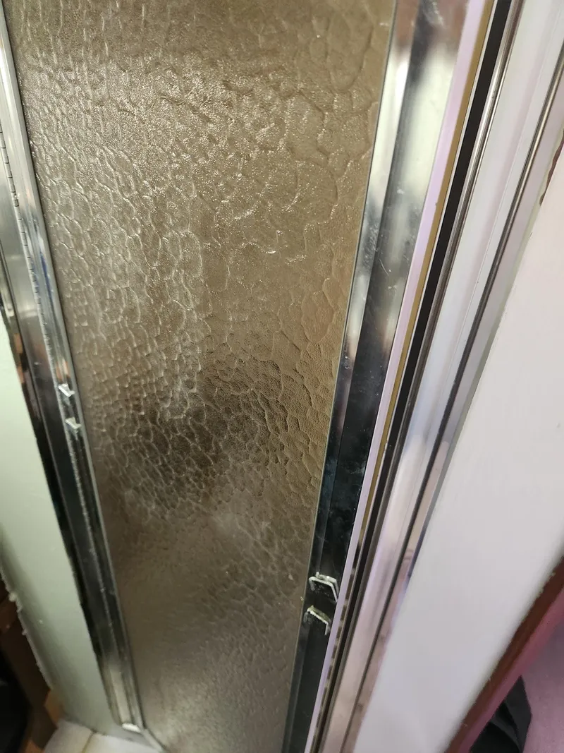 Slide: The Image of Textured glass door with metal frame on a 1977 Pacemaker 40 Sportfisherman boat. - 22