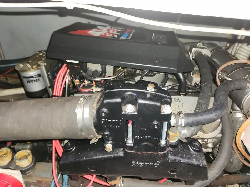 Slide: The Image of Engine components of a 1977 Pacemaker 40 Sportfisherman boat, featuring hoses and wiring. - 23