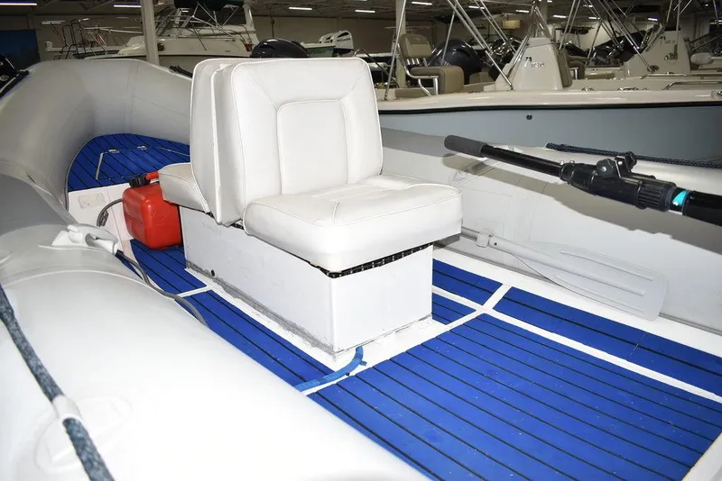Slide: The Image of 2018 Mercury 460 Ocean Runner Rib Inflatable boat interior with white seating and blue flooring. - 10
