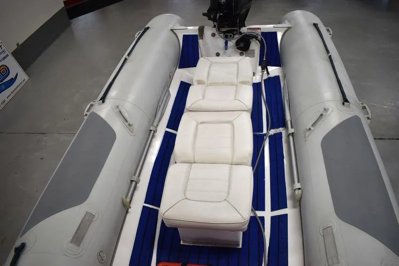 Slide: The Image of 2018 Mercury 460 Ocean Runner Rib Inflatable boat with white seating and blue flooring. - 11