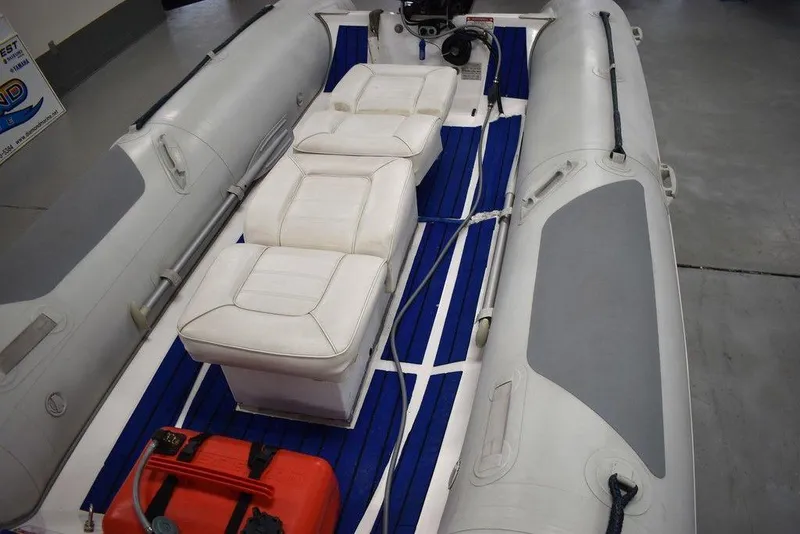 Slide: The Image of 2018 Mercury 460 Ocean Runner Rib Inflatable boat with white seating and blue flooring. - 12