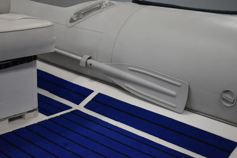 Slide: The Image of 2018 Mercury 460 Ocean Runner Rib Inflatable boat interior with blue flooring and paddle. - 18