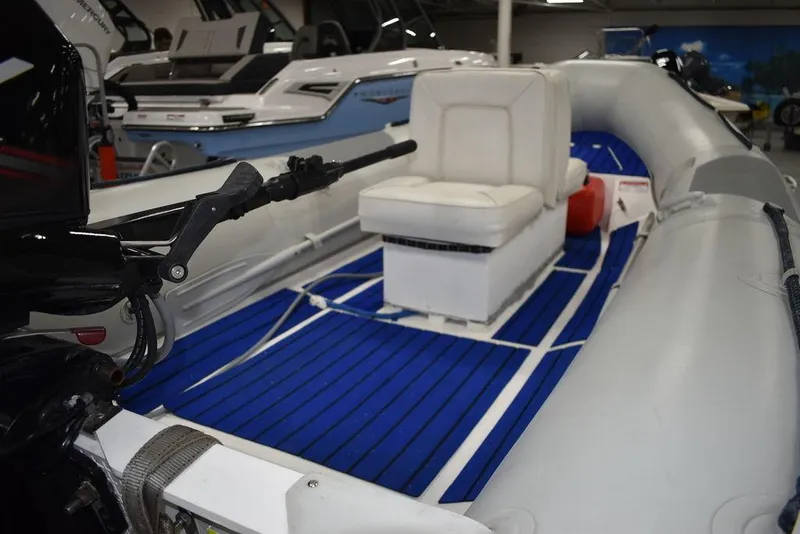 Slide: The Image of 2018 Mercury 460 Ocean Runner Rib Inflatable boat with blue flooring and white seating. - 7