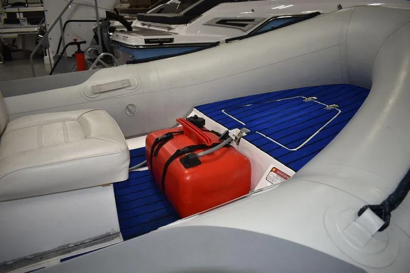 Slide: The Image of 2018 Mercury 460 Ocean Runner Rib Inflatable boat interior with red fuel tank. - 8