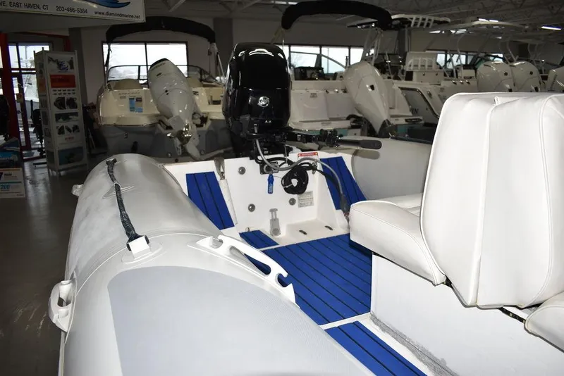 Slide: The Image of 2018 Mercury 460 Ocean Runner Rib Inflatable boat interior with blue flooring and white seating. - 9