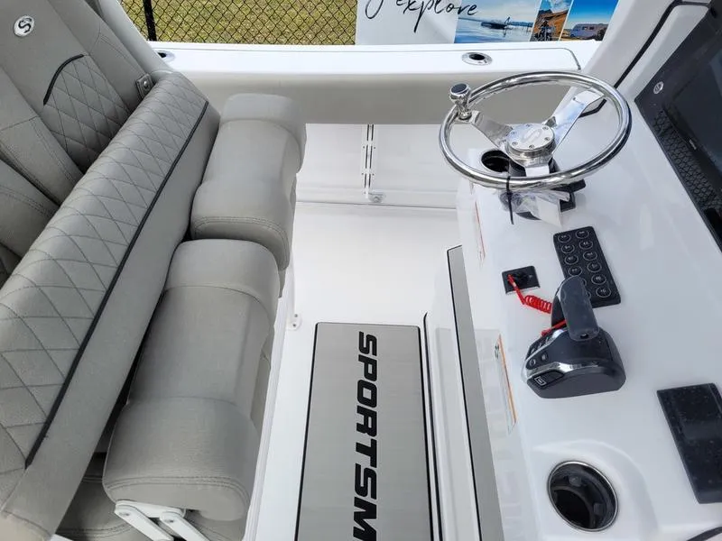 Slide: The Image of 2025 Sportsman Open 232 boat interior with steering wheel and control panel. - 12