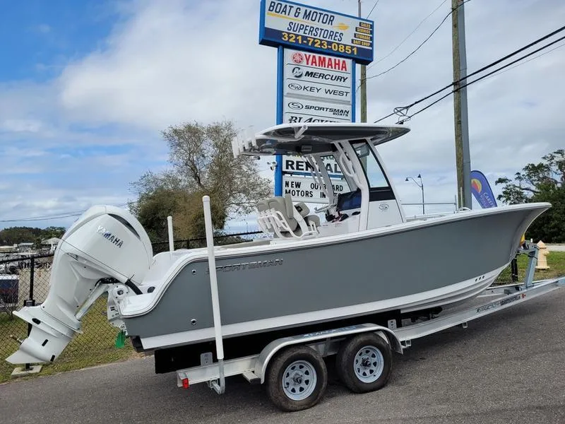 Slide: The Image of 2025 Sportsman Open 232 boat on trailer at dealership, featuring Yamaha engine. - 13