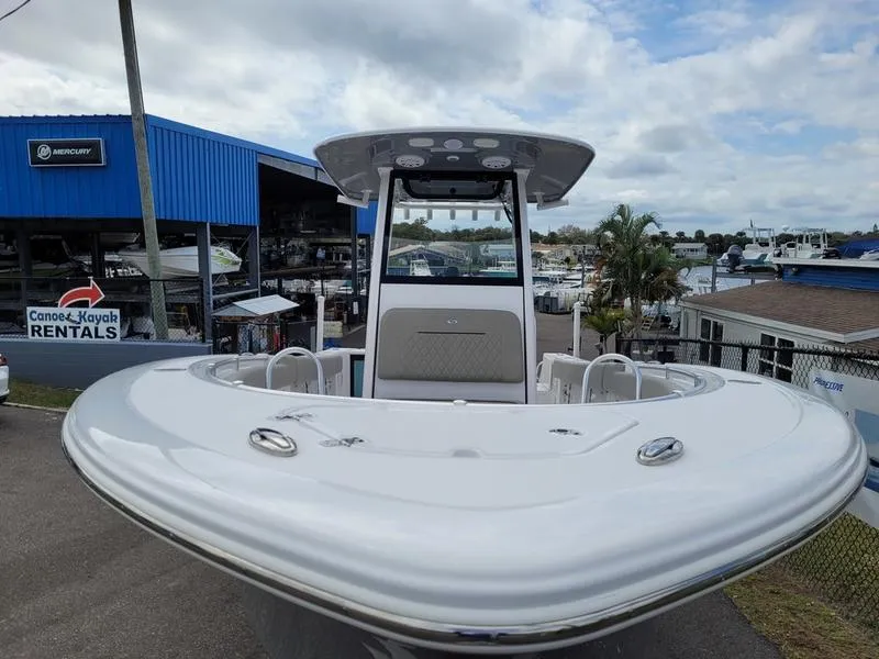Slide: The Image of 2025 Sportsman Open 232 boat at a marina, showcasing sleek design and modern features. - 2