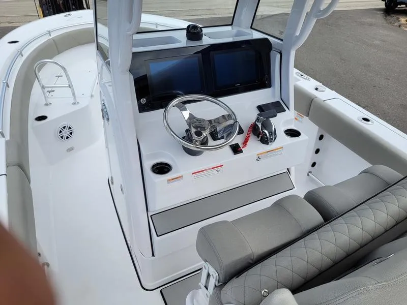 Slide: The Image of 2025 Sportsman Open 232 boat interior with modern dashboard and seating. - 7