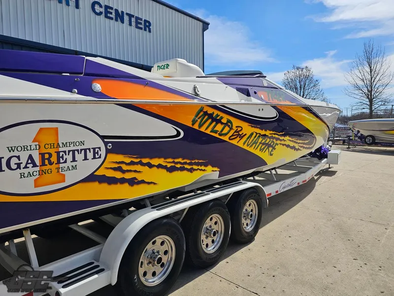 Slide: The Image of 2003 Cigarette 42 Tiger powerboat with vibrant racing graphics on a trailer. - 10