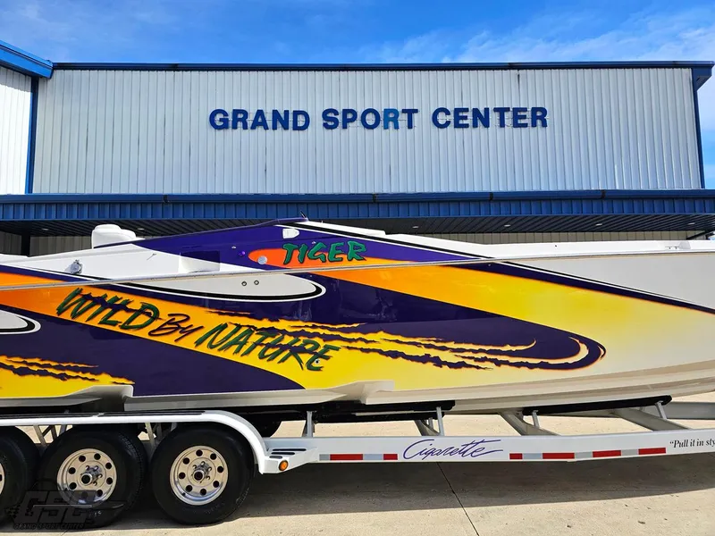 Slide: The Image of 2003 Cigarette 42 Tiger boat with vibrant graphics at Grand Sport Center. - 2