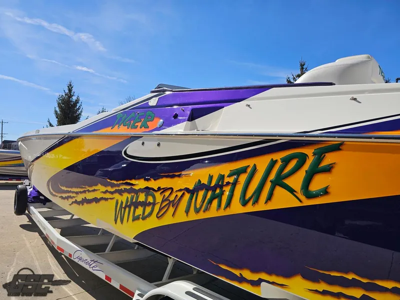 Slide: The Image of 2003 Cigarette 42 Tiger boat with vibrant "Wild by Nature" graphics. - 27