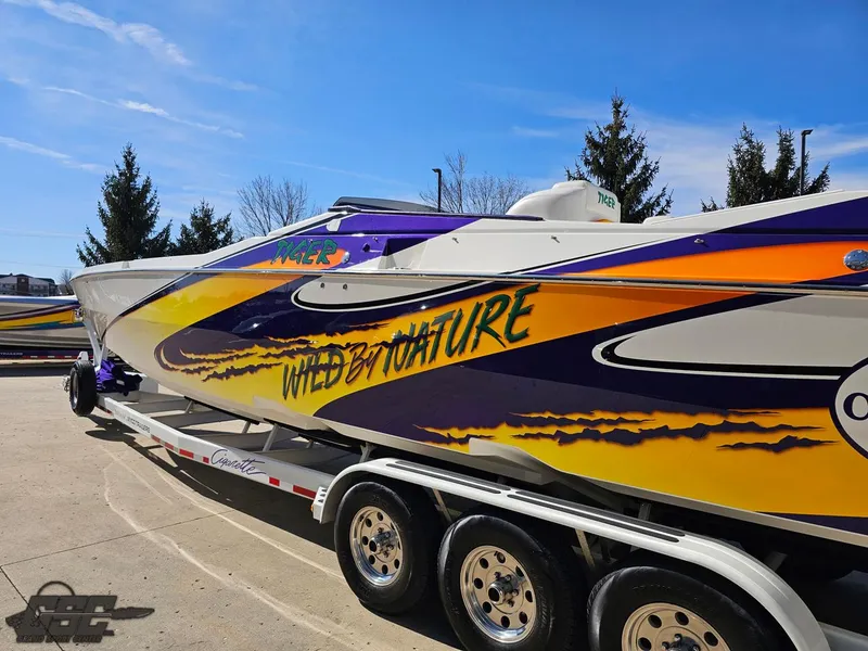Slide: The Image of 2003 Cigarette 42 Tiger speedboat with vibrant "Wild by Nature" graphics on a trailer. - 28