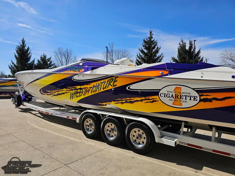 Slide: The Image of 2003 Cigarette 42 Tiger speedboat with vibrant graphics on a trailer. - 29