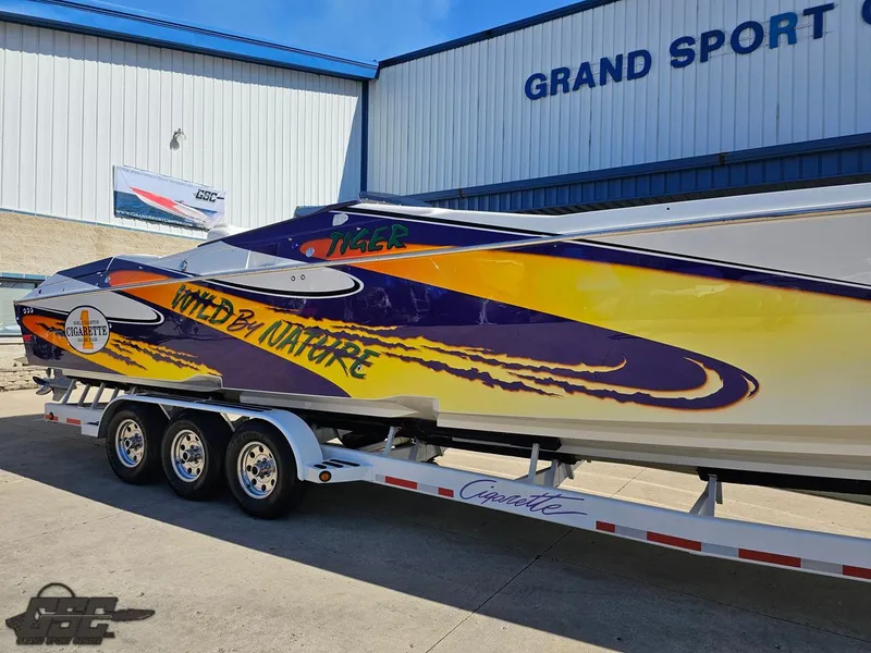 Slide: The Image of 2003 Cigarette 42 Tiger speedboat with vibrant graphics on a trailer at Grand Sport Center. - 3
