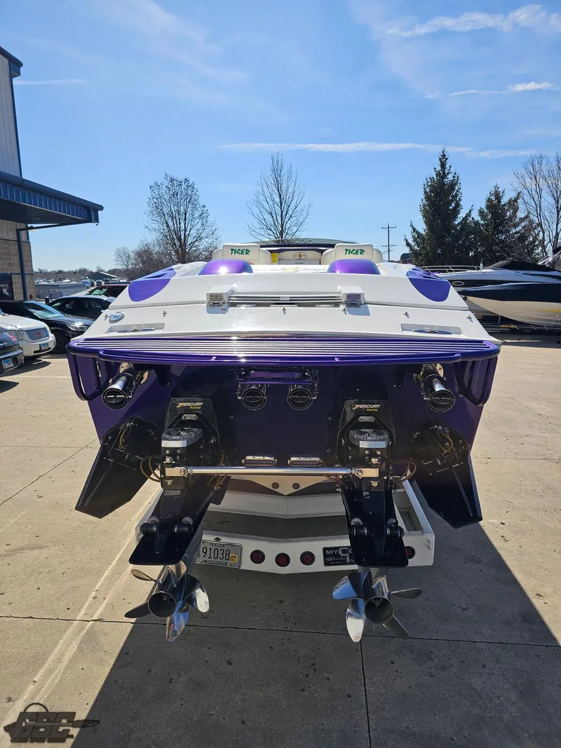 Slide: The Image of 2003 Cigarette 42 Tiger boat, rear view, dual propellers, parked outdoors. - 42