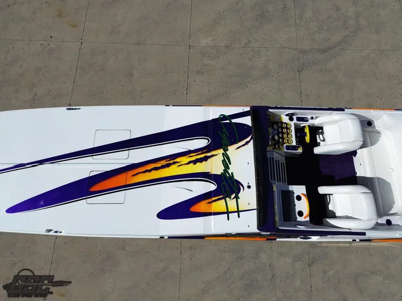 Slide: The Image of 2003 Cigarette 42 Tiger boat with vibrant purple and orange design, viewed from above. - 45