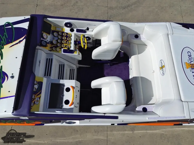 Slide: The Image of 2003 Cigarette 42 Tiger boat interior with white seating and colorful dashboard. - 46